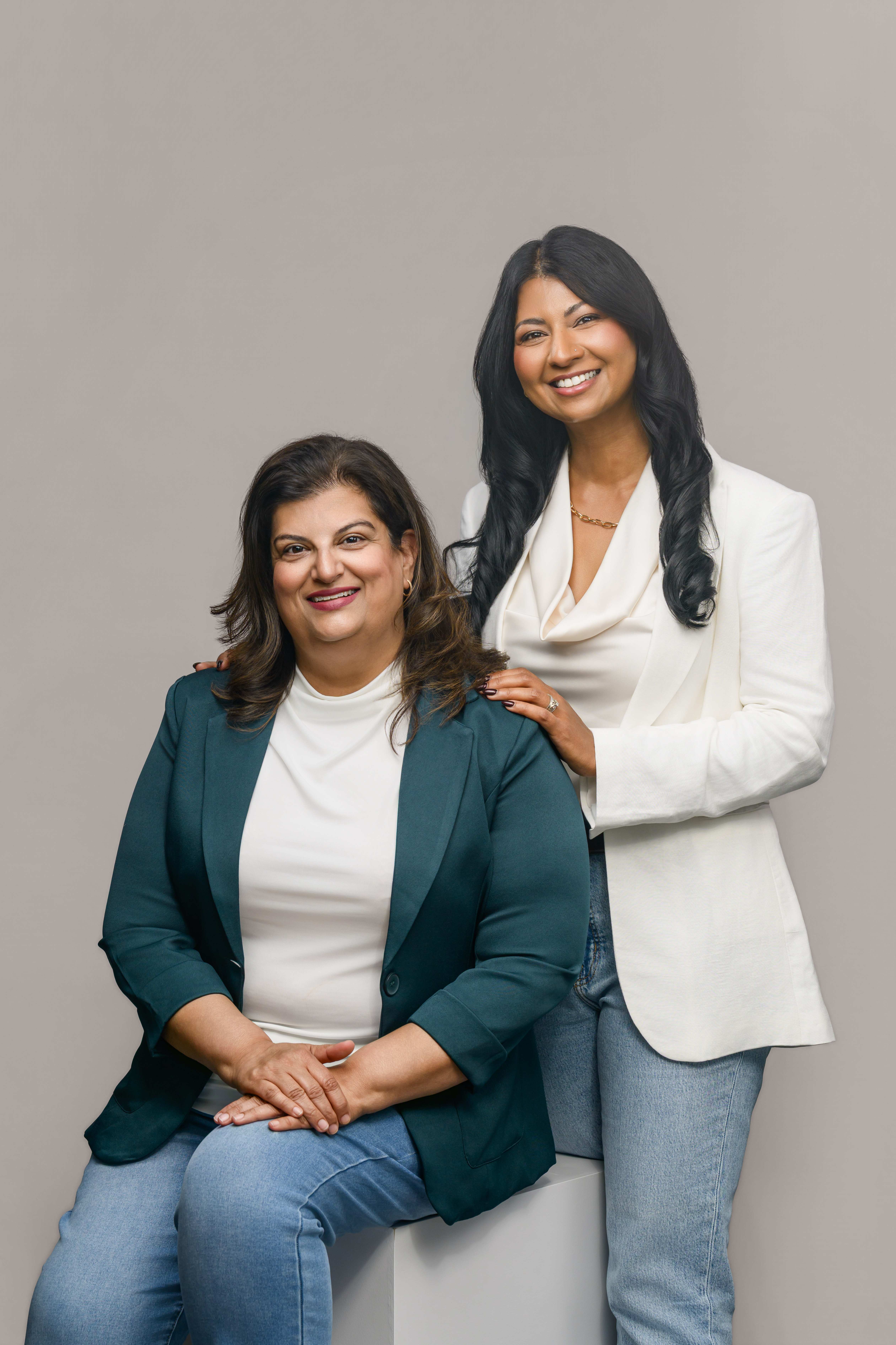 The two founders of Saath Wellness together in a warm studio portrait