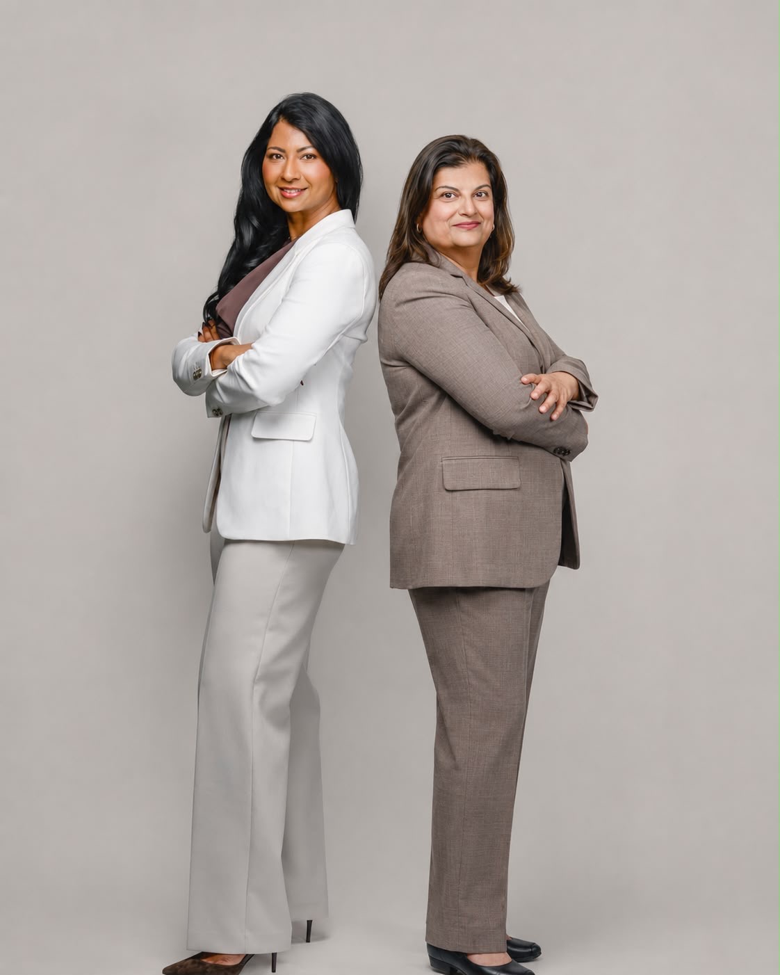 The two founders of Saath Wellness standing back to back in a studio portrait